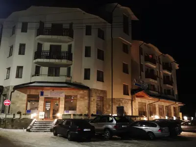 a building with cars parked in front of it at night at Borovets Hotel Villa Park in Borovets