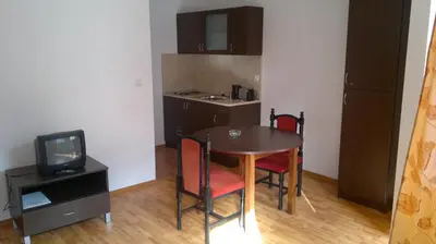 a small room with a table and chairs and a television at Borovets Holiday Apartments - Different Locations in Borovets in Borovets