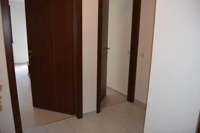 a hallway with two doors and a mirror at Borovets Holiday Apartments - Different Locations in Borovets in Borovets