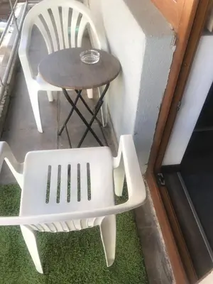 a table and two chairs next to a table and a stool at Lilia 2 Self-Check in apartment in Sofia