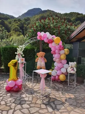 a balloon arch with teddy bears and tables and chairs at Family Hotel Enica in Teteven