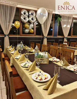 a long table with plates of food and balloons at Family Hotel Enica in Teteven