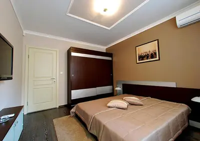 a bedroom with a bed with two pillows on it at Venice Apartments in Sofia