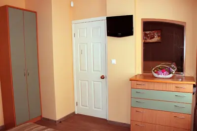 a kitchen with a white door and a dresser at Venice Apartments in Sofia
