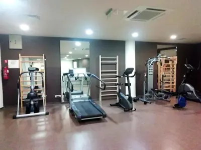 a gym with several tread machines in a room at Aspen golf studio apartment D208 in Razlog