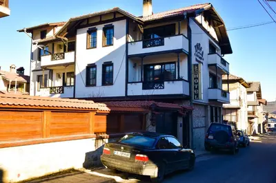 a black car parked in front of a building at Hotel St. George Pobedonosets in Bansko