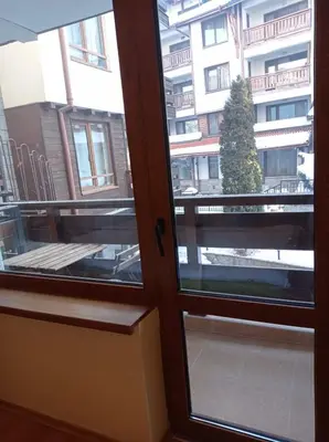 an open door with a view of a building at Pine Tree Apartment 3 - B3 in Bansko