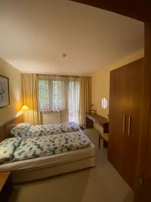 a bedroom with a bed and a desk in it at HQ apartments Villa Park in Borovets