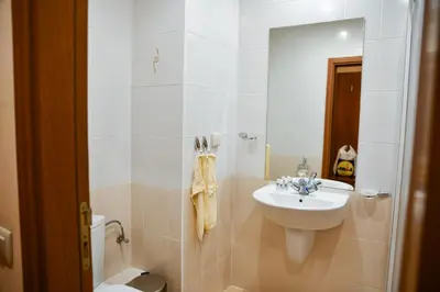 a bathroom with a sink and a toilet at HQ apartments Villa Park in Borovets