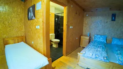 a bedroom with a bed and a bathroom with a toilet at Debeli Dab in Stara Kresna