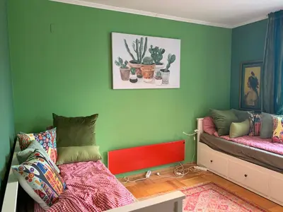 a green room with a bed and a couch at Gondola Flat Number 5 in Bansko