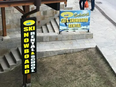 a sign for a ski shop on the side of the street at Gondola Flat Number 5 in Bansko