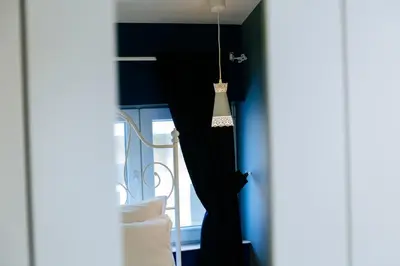 a room with blue walls and a hanging lamp at Beautiful best location apartment 