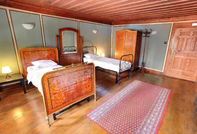 a bedroom with two beds and a mirror at Guest House Old Plovdiv in Plovdiv