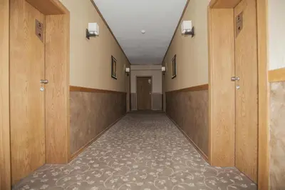 an empty corridor with wooden doors and a hallway with at Family Hotel Saint George in Sofia