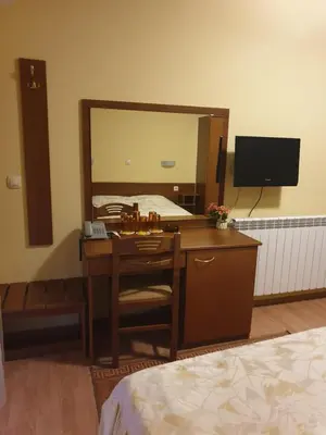 a bedroom with a desk and a large mirror at Guesthouse Kiritsovi in Bansko