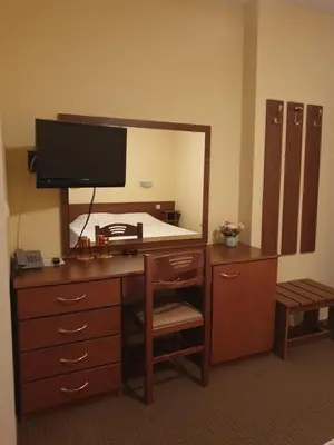 a bedroom with a desk with a large mirror at Guesthouse Kiritsovi in Bansko