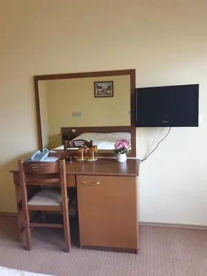 a desk with a sink and a mirror in a room at Guesthouse Kiritsovi in Bansko