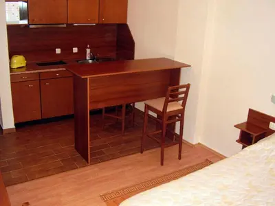 a kitchen with a sink and a desk with a chair at Guesthouse Kiritsovi in Bansko