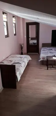 a bedroom with two beds and a mirror in it at Guest House Ideal in Sapareva Banya