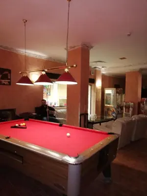 a living room with a red pool table in it at Grand Monastery - Azure Apartment in Pamporovo
