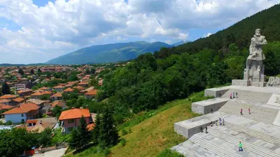 a large statue on top of a hill with a city at Mania Guest House in Kalofer