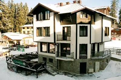 a house in the snow with snow at СТАИ ЗА ГОСТИ в КЪЩА КАМЕЛИЯ in Pamporovo