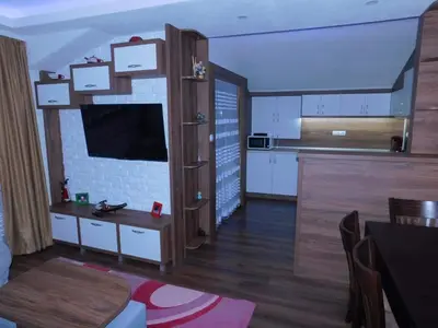 a living room with a kitchen and a dining room at Vihren Boutique Apartment in Bansko