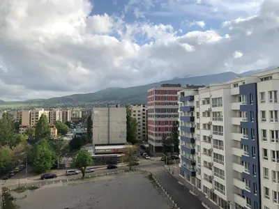 a view of a city with buildings and mountains at Turquoise and Magenta Apartments in Sofia