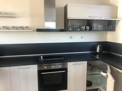 a kitchen with a black counter top and a stove at VILLA RELAX in Tsigov Chark