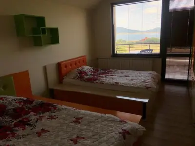 a bedroom with two beds and a window with a view at VILLA RELAX in Tsigov Chark