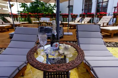a table with a bottle of wine and glasses on it at Boutique & Spa Hotel Heaven in Velingrad