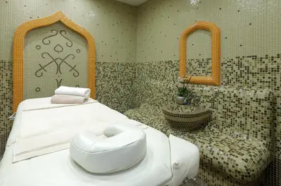 a bathroom with a bed and a sink and a tub at Boutique & Spa Hotel Heaven in Velingrad