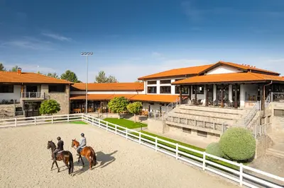 two people riding horses in front of a building at Boutique Complex Trakiets in Zhitnitsa