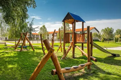 a park with a wooden playground with a slide at Boutique Complex Trakiets in Zhitnitsa