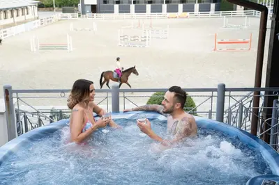 a man and a woman in a jacuzzi in a hot tub at Boutique Complex Trakiets in Zhitnitsa