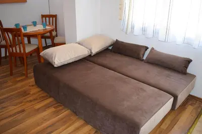 a large brown couch in a room with a table at Ramada 2 - Apartment in Bansko