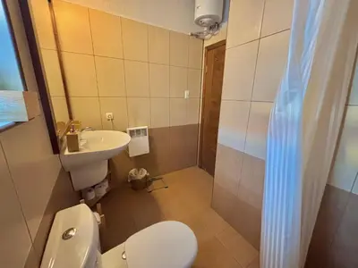 a small bathroom with a toilet and a sink at Villa Bachevo Horizon in Bachevo