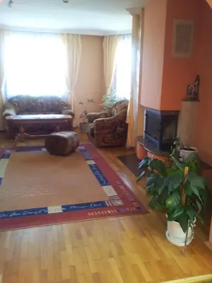 a living room with a couch and a fireplace at Guest House Tabakovi in Velingrad