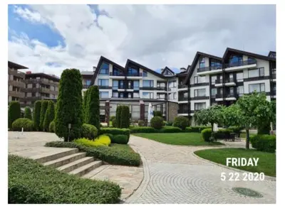 a large apartment building with a walkway in front of it at Studio L006 in Aspen Golf in Bansko