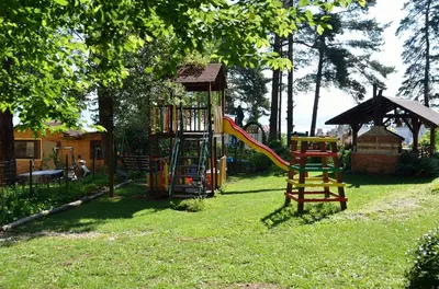 a playground with a slide in the grass at Vila Kalvachevi in Tsigov Chark