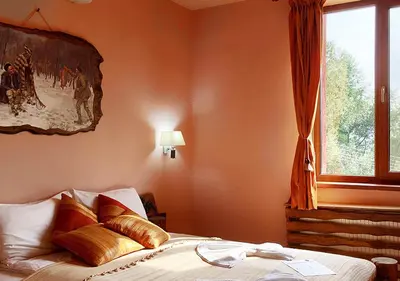 a bedroom with a bed with gold pillows and a window at Villa Mark in Kraevo