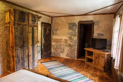 a living room with a television and a wooden table at Villa Mark in Kraevo