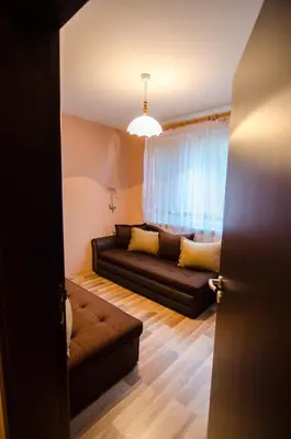 a living room with a couch and a window at Kapana Comfy 2BR Apartment in Top Center in Plovdiv