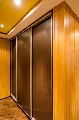 a closet with wooden walls and a metal door at Kapana Comfy 2BR Apartment in Top Center in Plovdiv