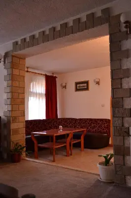 a living room with a couch and a table at Family Hotel Silver in Smolyan