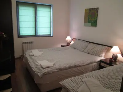 two beds in a small room with two lamps at Gramadeto Complex Alexander Services Apartments in Bansko