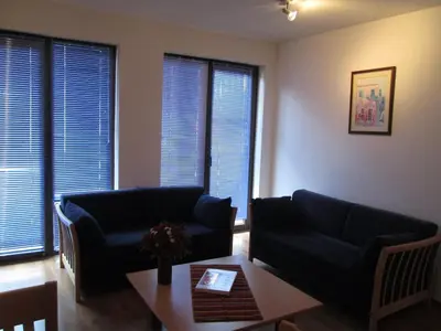 a living room with a couch and a table at Gramadeto Complex Alexander Services Apartments in Bansko