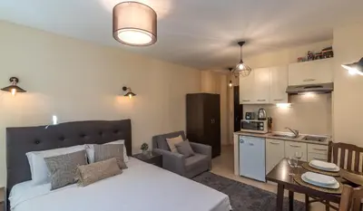 a bedroom with a bed and a small kitchen at ★ Stylish & Cozy Studios in Valentina Heights Boutique Hotel ★ in Bansko