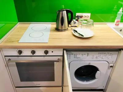 a kitchen with a counter with a stove and a counter top at Turquoise and Magenta Apartment in Sofia